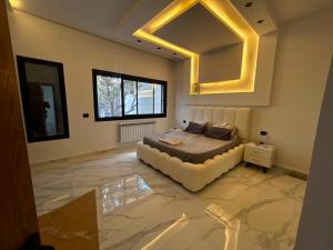 a bedroom with a bed and a large mirror at Villa zhara in Bizerte