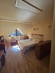 a large bedroom with a bed and a large window at Pokojíček 512 in Lázně Luhačovice