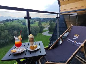 a table with two plates of food and a drink at Siedmiu Króli Rooms&SPA in Bukowina Tatrzańska
