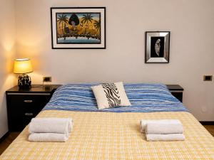 a bedroom with a bed with two towels on it at La Dolce vista, Lecco apartment with lake view in Malgrate