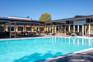 a large swimming pool in front of a building at Hotel Balka Strand in Neksø
