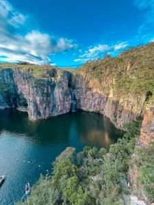 a view of a canyon with a boat in the water at Casa da Conceição in Capitólio