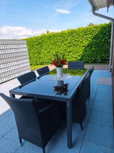 a blue table with chairs and a vase with flowers on it at Marina in Bleckede
