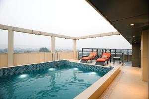 a swimming pool on the roof of a building at The ELET near Amritsar Airport in Amritsar
