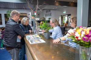 a group of people standing around a counter in a store at Hotel Balka Strand in Neksø +88 photos