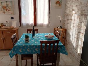 a dining room table with a blue table cloth on it at I Due Ciuchini Sardinia in Sassari