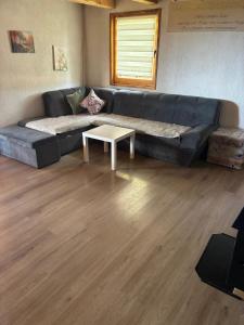 a living room with a couch and a coffee table at Planinski Kutak in Vareš