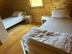 a bedroom with two beds in a log cabin at Planinski Kutak in Vareš