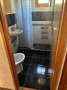 a small bathroom with a sink and a toilet at Planinski Kutak in Vareš