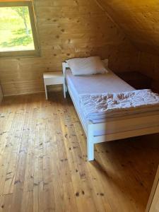 a bedroom with a bed in a wooden cabin at Planinski Kutak in Vareš
