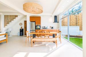 a dining room with a wooden table and chairs at Beachfront Dream in Ban Tai in Ban Tai