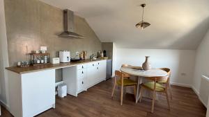 a kitchen with a table and a dining room at Nikola apartman in Arilje