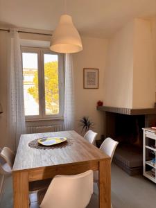 a dining room with a wooden table and white chairs at Casa Dolce Casa in Guardiagrele