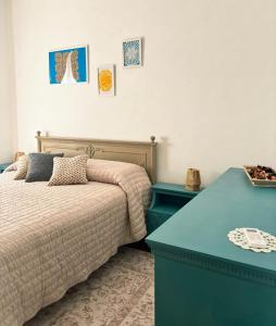 a bedroom with a bed and a blue table at Casa Dolce Casa in Guardiagrele