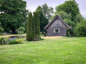a small house in the middle of a green field at Ruhnu Bullers-Gita talu in Ruhnu
