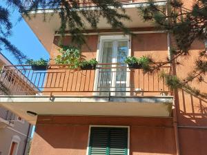 a balcony with potted plants on a building at Casa Dolce Casa in Guardiagrele