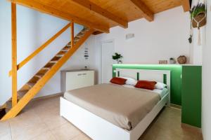 a bedroom with a bed and a staircase at Poseidonia nel Borgo in Pulsano