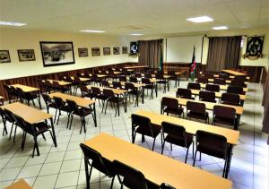 a classroom with rows of tables and chairs at Ngandu Hotel - Rundu in Rundu +43 photos