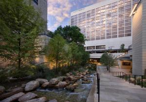 a river in front of a building next to a building at Hyatt Regency San Antonio Riverwalk in San Antonio