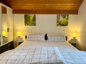 a bedroom with a bed with two pictures on the wall at Apartment Vinomna in Rankweil