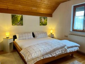 a bedroom with a bed and two lamps on the wall at Apartment Vinomna in Rankweil +21 photos