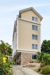 a tall building with a building at DO Hotel in Da Lat