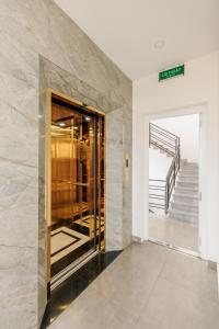 an elevator in a building with a stone wall at DO Hotel in Da Lat