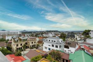 a city skyline with buildings and a blue sky at DO Hotel in Da Lat +19 photos
