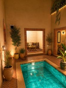 a swimming pool in the middle of a patio with plants at Hiking Nomads Guesthouse in Tamellalt