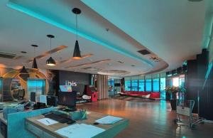 a large room with a lobby with a desk at ibis Passo Fundo Centro in Passo Fundo