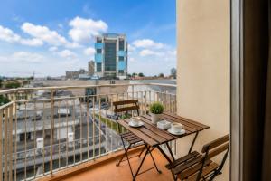 a balcony with a table and chairs and a view of a city at Hotel Vice-Rei in Porto