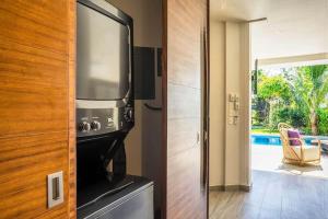 a kitchen with a stove and a microwave at Villa 34 I Puerto Aventuras I Private Pool in Puerto Aventuras +14 photos
