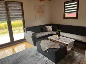 a living room with a couch and a table at Planinska Idila in Vareš