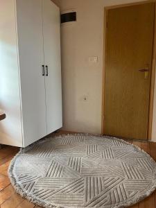 a room with a large rug on the floor next to a door at Planinska Idila in Vareš