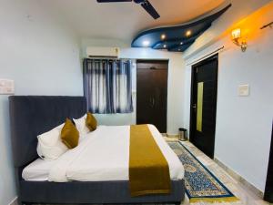 a bedroom with a large bed with yellow pillows at The Commune Varanasi in Varanasi