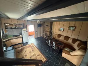 a living room with a couch and a kitchen at Горянка in Oryava