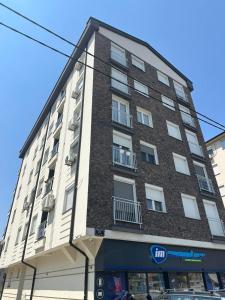 a large brick building on a city street at Apartman Laki in Bijeljina