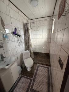 a small bathroom with a toilet and a sink at Горянка in Oryava