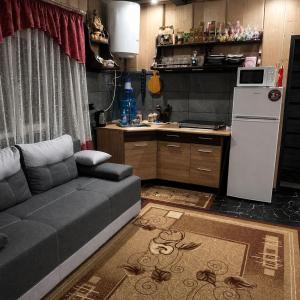 a living room with a couch and a kitchen at Горянка in Oryava +15 photos