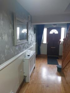 a room with a hallway with a door and a staircase at Levally hs mountrivers doonbeg co clare 