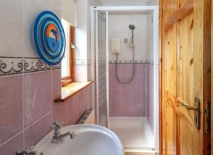 a bathroom with a sink and a shower at Levally hs mountrivers doonbeg co clare 