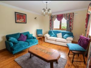 a living room with a couch and a table at Levally hs mountrivers doonbeg co clare 