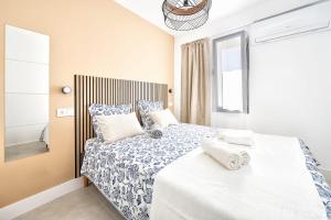 a bedroom with a large bed with white sheets and pillows at Casa Arizona Central Duplex Puerto Rico GC in Mogán