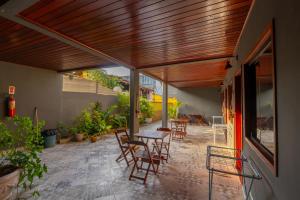 an outdoor patio with a table and chairs at BLUE DOOR BRASIL in Abraão