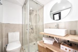 a bathroom with a toilet and a sink and a mirror at Casa Arizona Central Duplex Puerto Rico GC in Mogán +11 photos