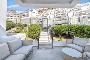 a balcony with couches and stairs in a building at Casa Arizona Central Duplex Puerto Rico GC in Mogán