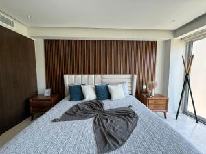 a bedroom with a bed with a bow on it at Departamento Diamante Azul Punta Mita, Beach Front in Punta Mita +35 photos