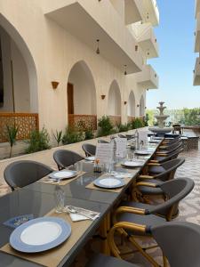 a long table with chairs and plates on it at El Bawaba Lodge & Luxury Retreat in Luxor