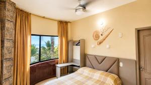 a bedroom with a bed and a large window at La Casa Ucraniana in Canoa +42 photos