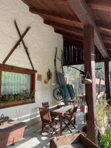 an outdoor patio with a wooden table and chairs at Agriturismo La Gerla in Cesana Torinese